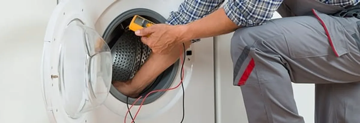 Dryer repair technician inspecting and repairing a clothes dryer in Fort Worth, TX