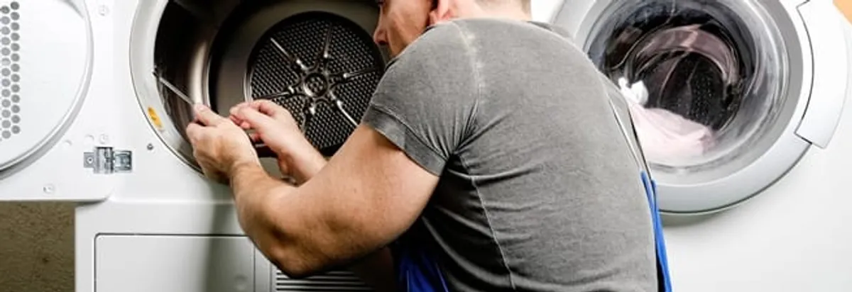 Dryer repair technician fixing a clothes dryer drum in Fort Worth, TX