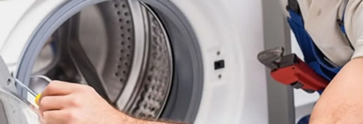 Appliance technician repairing a clothes dryer drum and internal parts in Fort Worth, TX