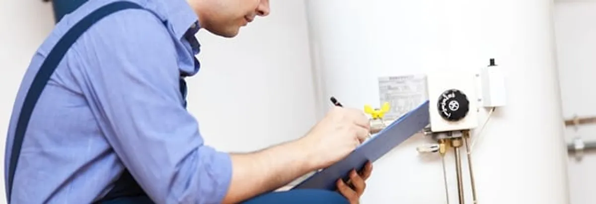 Water heater repair technician inspecting the unit and recording service notes in Fort Worth, TX
